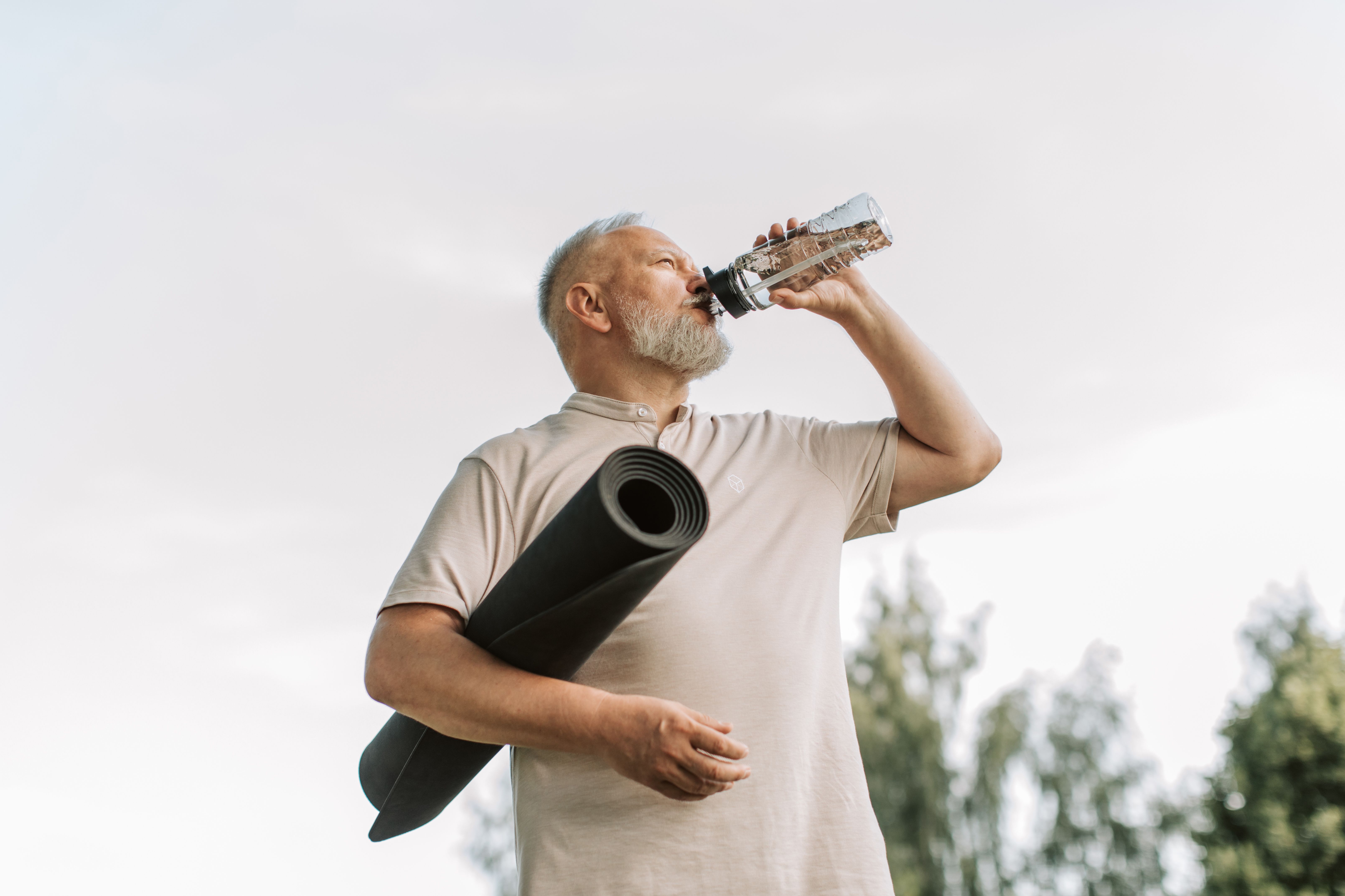 senior man drinking water outdoors hydration brain health