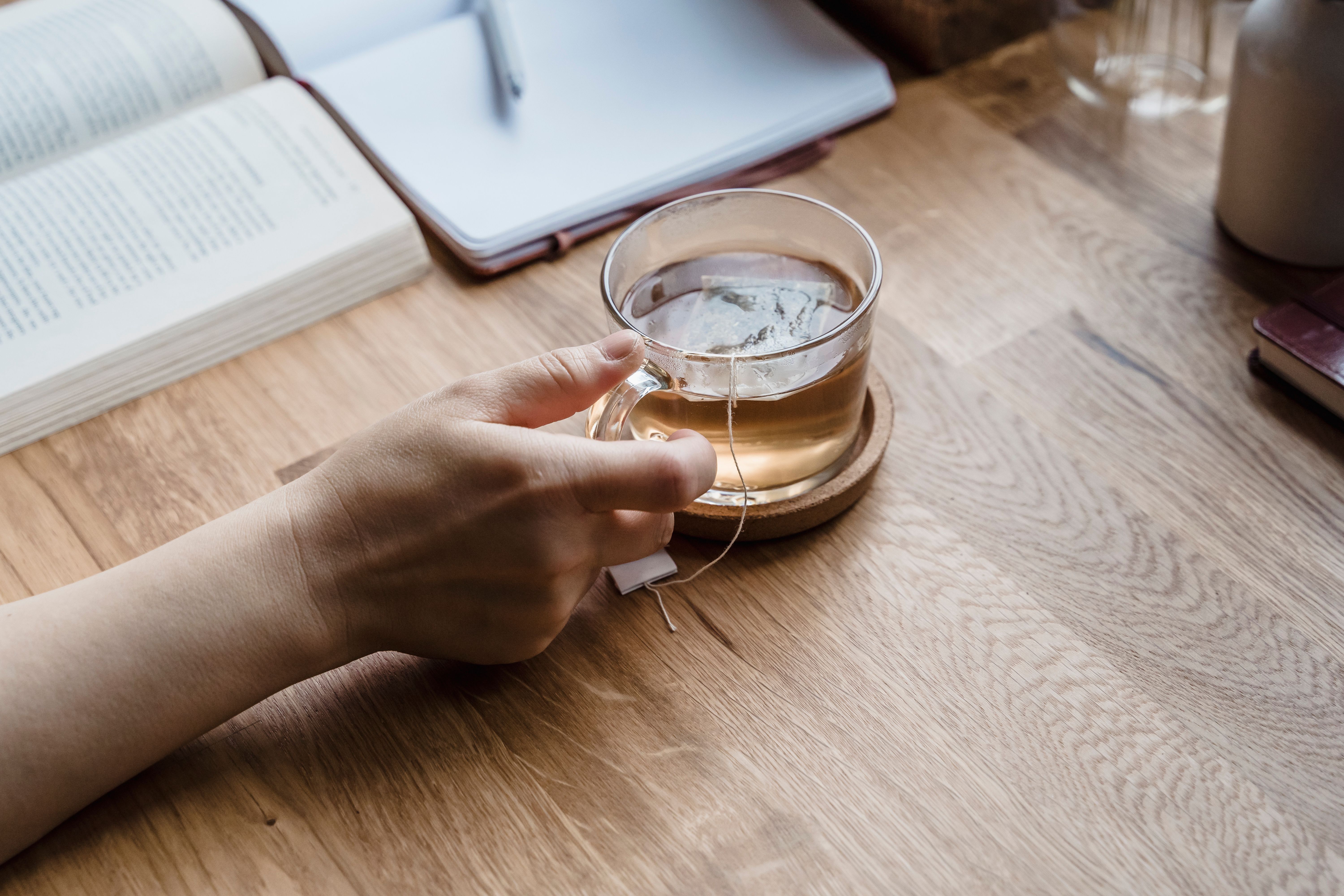 Glass of water for brain health and cognitive function in a morning routine, condensation on glass, bright bedroom background.
